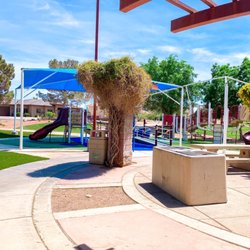Picnic benches to sit and eat at right next to playground