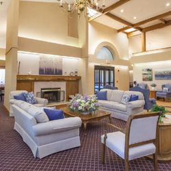 River Commons Senior Living - Community lobby with fireplace and seating area