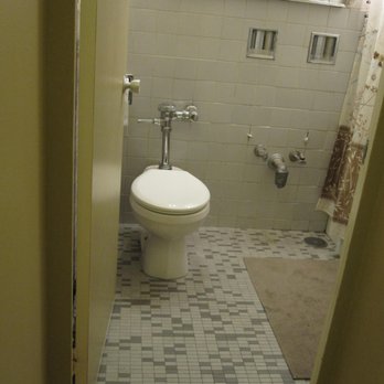 IRPINO Construction - Old Chicago high-rise bathroom.  Sink is already yanked and the small cast-iron tub is to the right. - General Contractors Near Me - Chicago, Illinois
