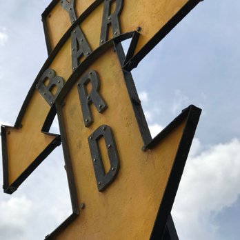 Yard Bar - a yellow arrow with the word yard on it - Bars Near Me - Orlando, Florida