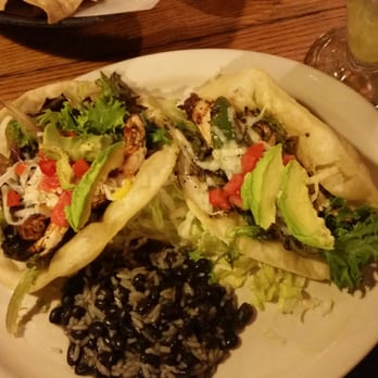 Trini's - Two puffy tacos, one with blackened chicken, the other with fajita chicken, and rice and black beans. So good! - Mexican Near Me - Omaha, Nebraska Trini's - Two puffy tacos, one with blackened chicken, the other with fajita chicken, and rice and black beans. So good! - Mexican Near Me - Omaha, Nebraska
