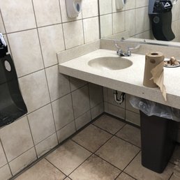 Men's restroom. "Touch less" Paper towel holder has been broken for over a year.