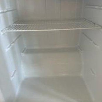 Transient Peace - An empty refrigerator with a wire shelf and a smooth interior surface. - Home Cleaning Near Me