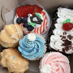 Sweet Caroline's Bakery - Mini cream puffs, vanilla cupcakes, Black Forest slice and a pavlova