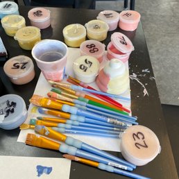 a table with paint and brushes a table with paint and brushes