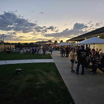 The Rush Event Center - a crowd of people standing and sitting under umbrellas - Amusement Parks Near Me - Evans, Colorado The Rush Event Center - a crowd of people standing and sitting under umbrellas - Amusement Parks Near Me - Evans, Colorado
