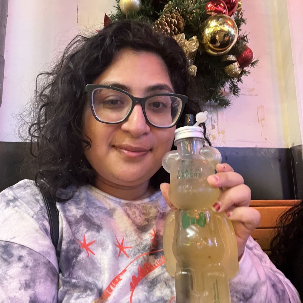 Tea Makers - a woman holding a glass of tea - Bubble Tea Near Me - Brooklyn, New York Tea Makers - a woman holding a glass of tea - Bubble Tea Near Me - Brooklyn, New York