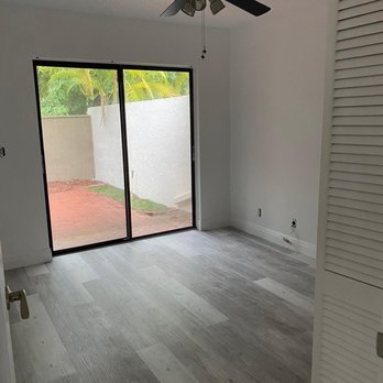 The Remodeling Team - an empty room with a ceiling fan - Painters Near Me The Remodeling Team - an empty room with a ceiling fan - Painters Near Me