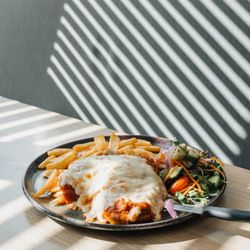 SOPO Southport - Classic Chicken Parmigiana, served with your choice of chips & salad or steamed greens & roasted chat potatoes.