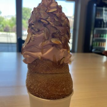 Crispy Cones - Sugar "cone" with strawberry soft serve with almonds and caramel drizzle. Absolutely delish!!! - Desserts Near Me - Logan, Utah