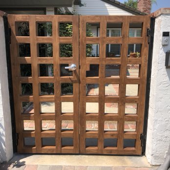 Castle Garage Doors - These steel frame and wood overlay gates are equipped with an electronic strike and WiFi audio and video entry. - Garage Door Services Near Me - Temecula, California