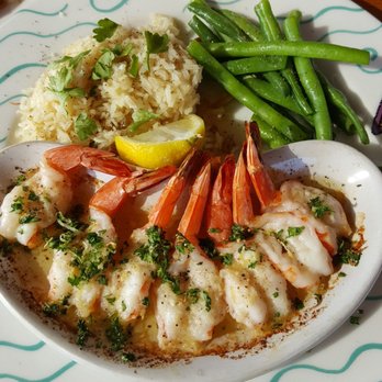 Anthony's Restaurant - Roasted Garlic Prawns in melted fresh herb butter, Meditterean style Basmati rice Pilaf, fresh briased Green Beans - Seafood Near Me - Bellingham, Washington