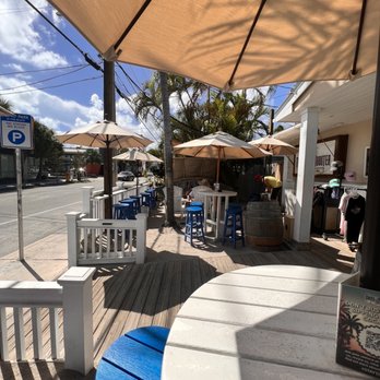 Tipsy Rooster Liquor Store and Bar - tables and umbrellas - Bars Near Me - Key West, Florida Tipsy Rooster Liquor Store and Bar - tables and umbrellas - Bars Near Me - Key West, Florida