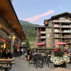 The Sutton Place Hotel - Rockford Patio at supper time with a view of the Revelstoke PIPE mountain coaster in the background