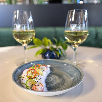 Tides - a plate of food and two glasses of wine - Seafood Near Me - Danville, California Tides - a plate of food and two glasses of wine - Seafood Near Me - Danville, California