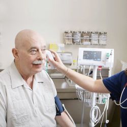 Hoag Family Medicine Irvine - Woodbury - Summer Carlson taking the temperature of a patient.