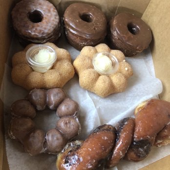 Friendly Donuts - We got 2 chocolate and 1 maple cronuts, 2 churro Mochi and one ube and finally tiger tail. - Donuts Near Me - Orange, California