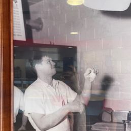 a man holding a pizza cutter a man holding a pizza cutter
