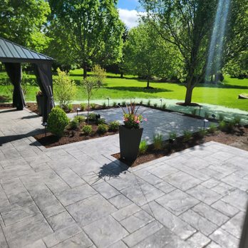 AV Concrete - A wide-angle shot demonstrating the patio's connection to the surrounding landscape. - Masonry/Concrete Near Me AV Concrete - A wide-angle shot demonstrating the patio's connection to the surrounding landscape. - Masonry/Concrete Near Me