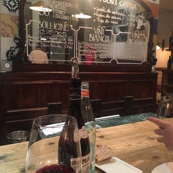L'Arcangelo - Sitting at the bar you can see the specials and wines by the glass written on the mirror. - Italian Near Me - Rome, RM