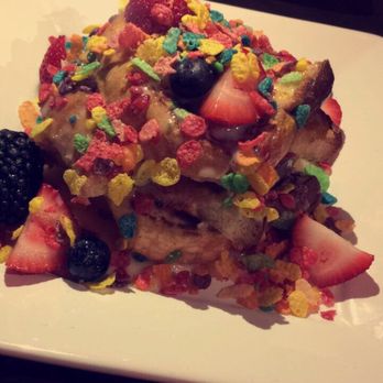 Bosscat Kitchen & Libations - The most beautiful French toast! The 2 bite wonder. Too sweet but sweet to look at Peek the plain burger in the background. - New American Near Me - Houston, Texas