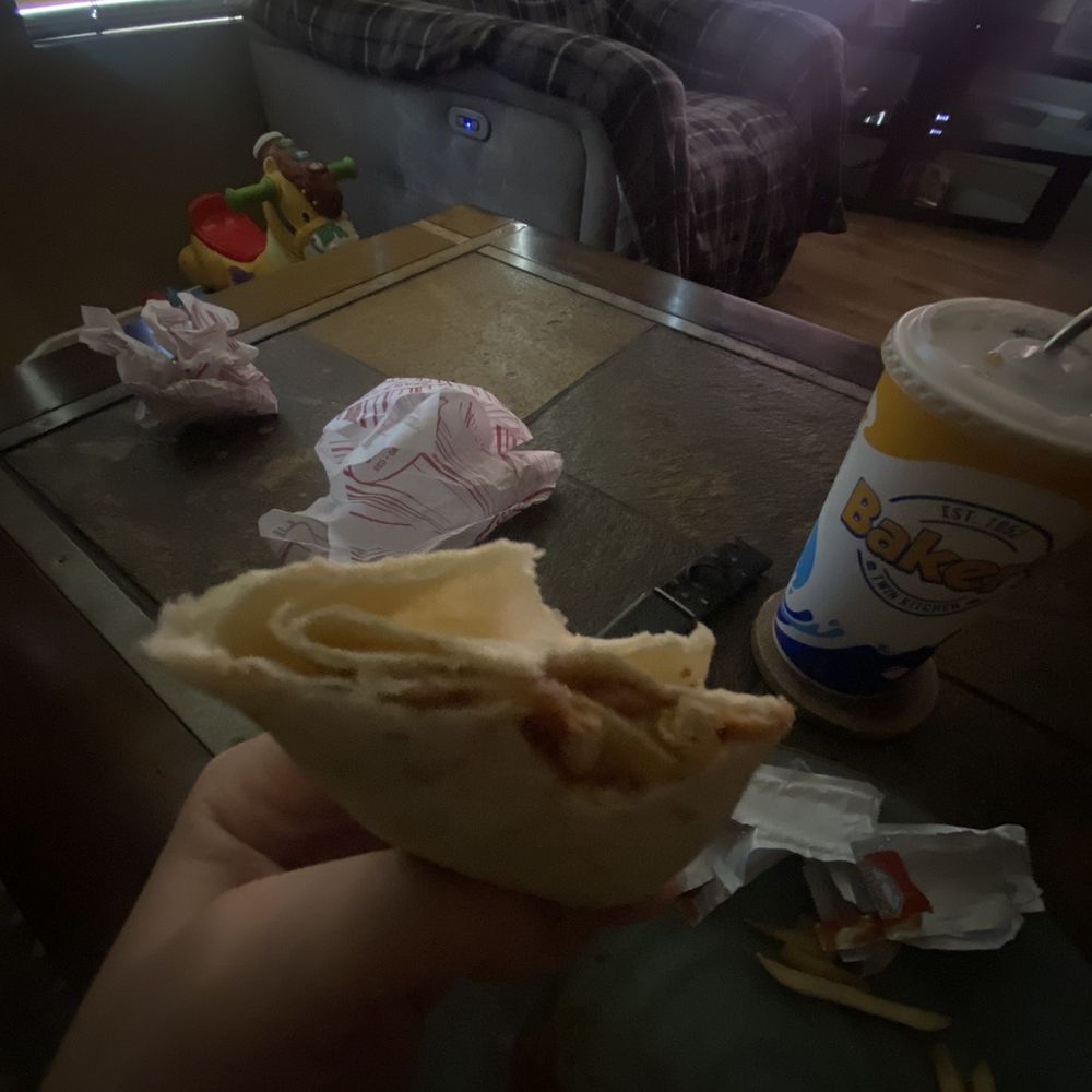 Baker's Drive-Thru - a person holding a sandwich - Burgers Near Me - Colton, California