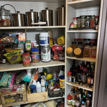 Trussell's Transformations - Pantry before. - A pantry with shelves containing spices, supplements, canned goods, and kitchen storage containers. - General Contractors Near Me - Albuquerque, New Mexico
