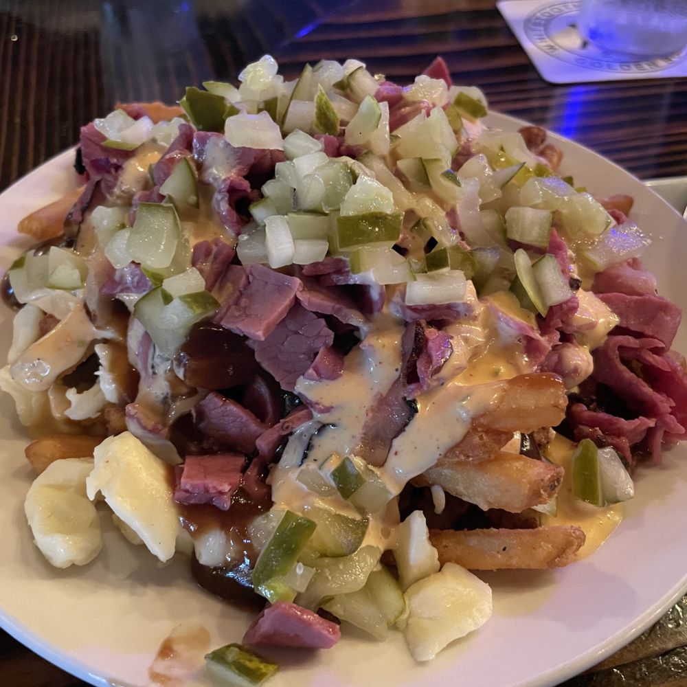 Poutine with Montreal Smoked Meat and chopped pickles. Poutine with Montreal Smoked Meat and chopped pickles.