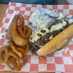 The Joint Burgers and BBQ - Philly Cheesesteak sandwich with onion rings