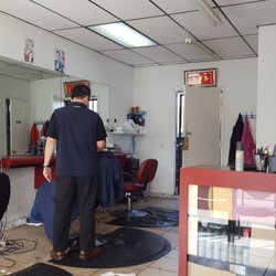 Young Hair Salon - Mr young at work..three waiting chairs inside, seems like 1 or 2 people work at a time..CASH ONLY