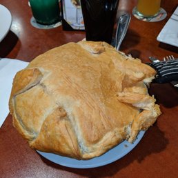The chicken pot pie is large, in a cast iron skillet, with a puff pastry crust. The chicken pot pie is large, in a cast iron skillet, with a puff pastry crust.