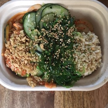 Poke Bar - A little squished because of the to-go lid but still delicious :) Double spicy tuna with cucumber and seaweed salad - Hawaiian Near Me - El Segundo, California