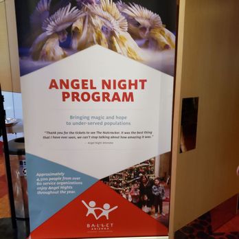 Symphony Hall - The banner promotes the Angel Night Program by Ballet Arizona, highlighting bringing hope to under-served populations. It includes a quote from an attendee, mentions serving over 4,500 people annually, and displays the Ballet Arizona logo. The top part shows an artistic image of a bird with outstretched wings, while the bottom part contains a group photo of children and adults at a ballet event. The banner is placed indoors on a red carpeted floor, partially obscured by a partition. - Performing Arts Near Me - Phoenix, Arizona