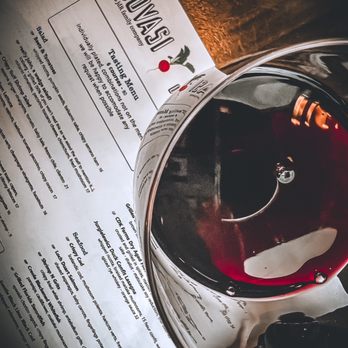 Inovasi - a glass of red wine on a table - New American Near Me - Lake Bluff, Illinois