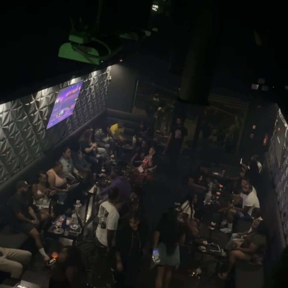 a crowd of people sitting at tables a crowd of people sitting at tables
