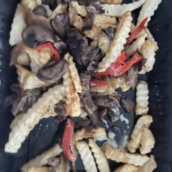 Pardon My Cheesesteak - Fries covered with peppers, steak, and cheese.
