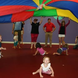 The Little Gym of Asheville - Beasts love exploring under the parachute!