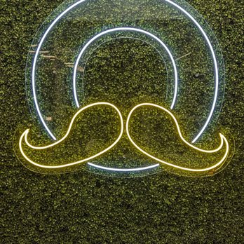 Dosa Boyz - a neon sign with a mustache - Indian Near Me - Toronto, Ontario