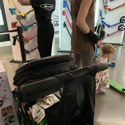 Micro Kickboard - The lady on the left with the micro shirt putting a supposedly customer's scooter back