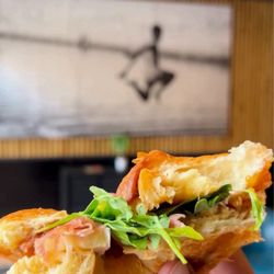 Victus Coffee - Prosciutto, Brie, and fig jam on a croissant