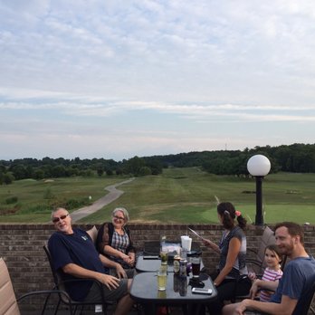 Mulligan's - a group of people sitting around a table - Sports Bars Near Me - Gosport, Indiana