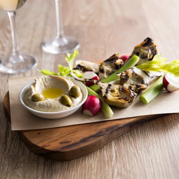 Seasons 52 - Grilled Artichokes with Preserved Lemon Hummus served with celery hearts, radishes, crispy lavash and green olives - New American Near Me - Plano, Texas Seasons 52 - Grilled Artichokes with Preserved Lemon Hummus served with celery hearts, radishes, crispy lavash and green olives - New American Near Me - Plano, Texas