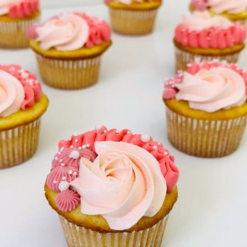 Windy City Baker - Cupcakes with multiple shades of pink frosting and decorated with a variety of piped designs and white edible pearls. - Bakeries Near Me - Chicago, Illinois Windy City Baker - Cupcakes with multiple shades of pink frosting and decorated with a variety of piped designs and white edible pearls. - Bakeries Near Me - Chicago, Illinois