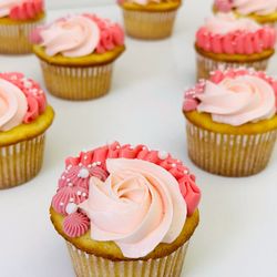 Windy City Baker - Cupcakes with multiple shades of pink frosting and decorated with a variety of piped designs and white edible pearls.