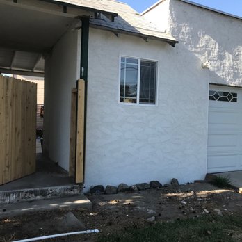 Divine Remodels and More - Nice match on the Stucco, Reframed the entire corner, repaird roof, installed window, washerdryer hookups, water heater, and garage door. - Tree Services Near Me - Alta Loma, California