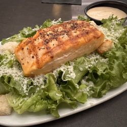 Salmon topped Caesar salad