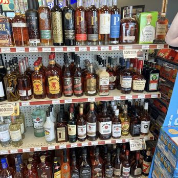 Phillips 66 - Bourbon - Display of whiskey and liquor bottles on store shelves, including brands like Knob Creek, Fireball, Jim Beam, and others, with price tags visible. - Gas Stations Near Me - Casey, Illinois
