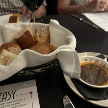 Vernon's Speakeasy - Plain flavorless dry white bread with good spicey oil. - Steakhouses Near Me - Los Ranchos, New Mexico