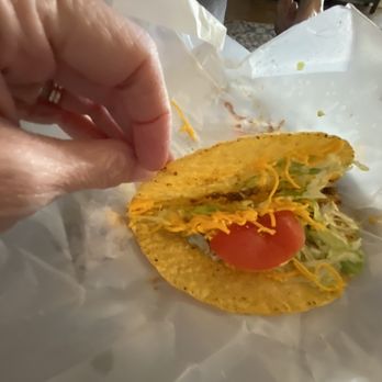 Baker's Drive-Thru - a hand holding a taco - Burgers Near Me - Bloomington, California Baker's Drive-Thru - a hand holding a taco - Burgers Near Me - Bloomington, California