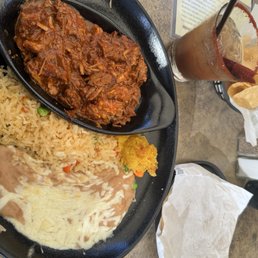 Chile Colorado (spicy) plate that comes with rice, beans, corn pudding and tortillas   Tamarindo Margarita on the side